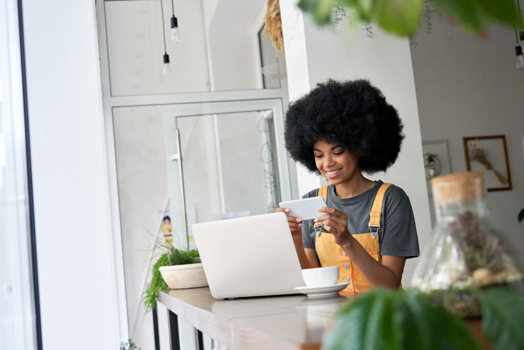 Smiling woman student watching mobile